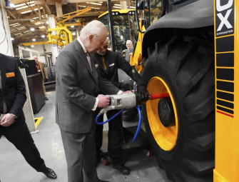 King greeted by cheering crowds at JCB headquarters in Staffordshire Image