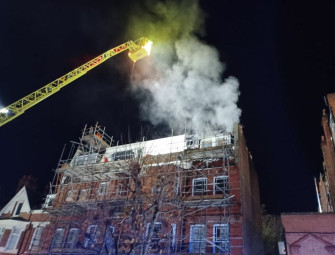 Around 100 firefighters tackling takeaway flat blaze Image