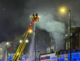 Five people in hospital after fire breaks out at takeaway and flats Image