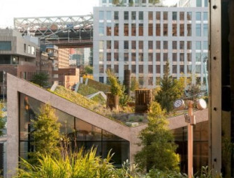 Angular concrete buildings surround Domino Square plaza Image