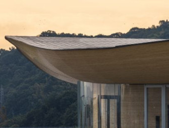 Kengo Kuma tops sculptural community centre with swooping bamboo roof Image