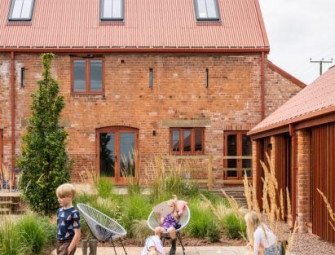 Stolon Studio converts 15th-century farm building into brick and timber housing complex Image